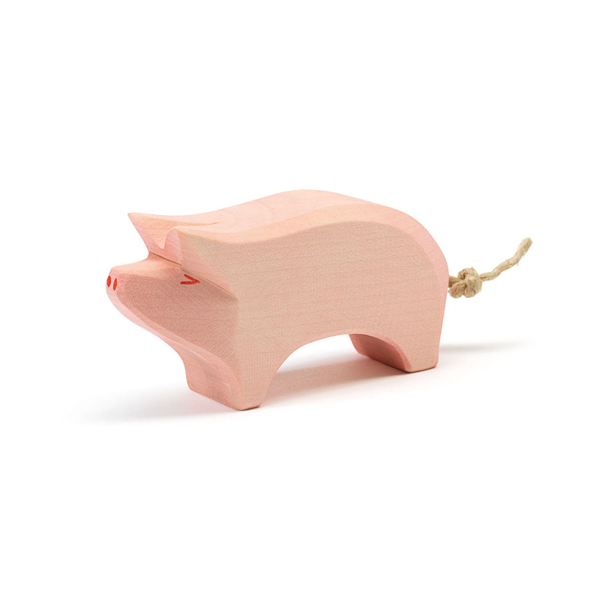 Ostheimer Holzfigur Schwein in Rosa mit erhobenem Rüssel und Seilschwanz