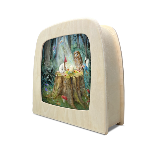 Toverlux Silhouettenlampe aus hellem Holz, seitliche Ansicht der abgerundeten Box mit Waldszene