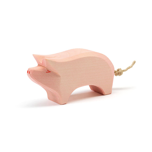 Ostheimer Holzfigur Schwein in Rosa mit erhobenem Rüssel und Seilschwanz