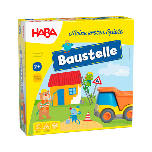 Haba Meine ersten Spiele Baustelle, Verpackung mit gelbem Rand, buntem Baustellen-Motiv und orange-blauem Spielzeug-Lastwagen
