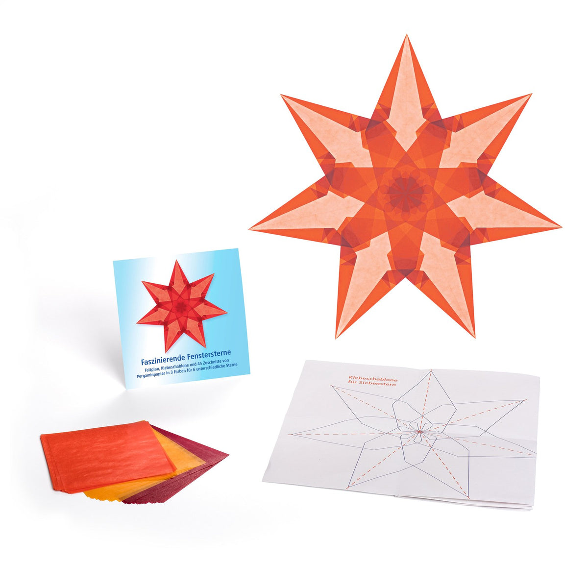 Ausgepacktes Set Faszinierende Fenstersterne: Kartontasche, Pergaminpapier in Rot, Orange und Gelb, Faltplan und ein fertiger orangefarbener Stern