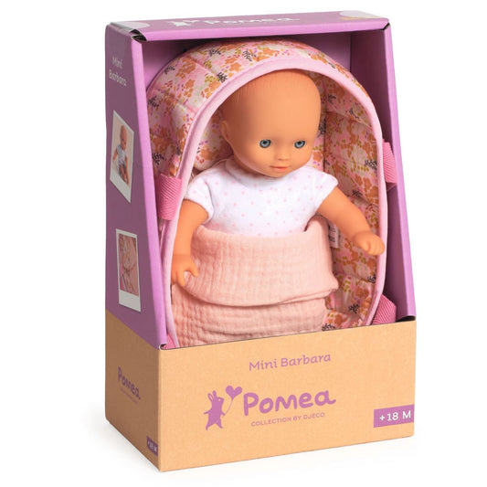 Pomea Mini Barbara Verpackung mit Puppe im weißen Shirt, liegend im rosa geblümten Moses-Körbchen