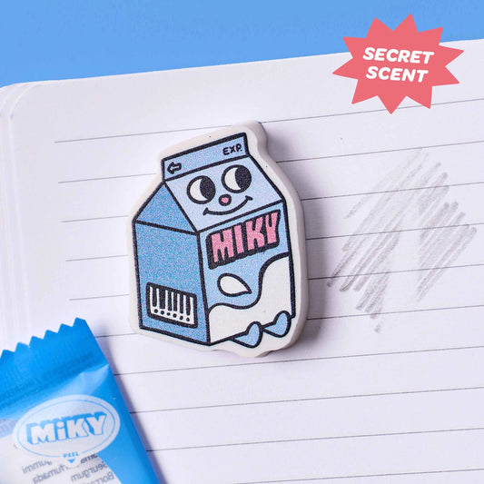 OMY Eraser Buddies Radierer Milchkarton mit Gesicht und rosa Schriftzug auf liniertem Papier