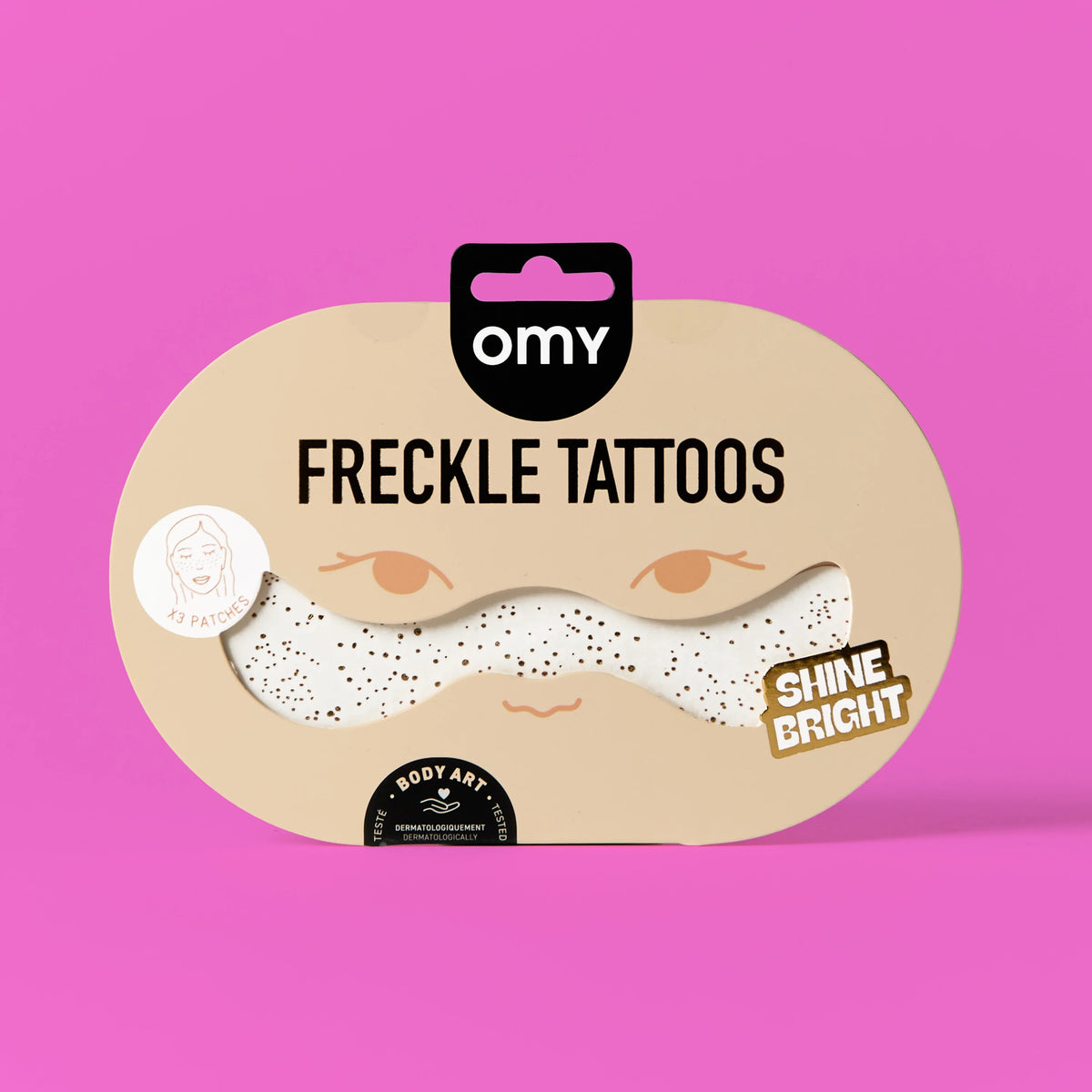 Verpackung OMY Freckle Tattoos Shine Bright mit weißem glitzerndem Sommersprossen-Tattoo auf rosa Grund