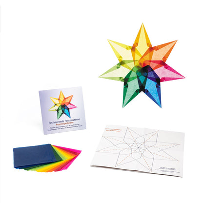 Ausgepacktes Set Faszinierende Fenstersterne Regenbogenfarben: Kartontasche, Pergaminpapier in acht Farben, Faltplan und ein fertiger Regenbogenstern