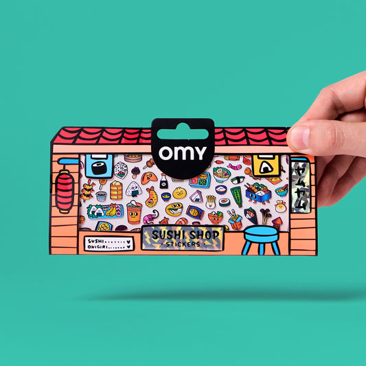 OMY Boutique Sushi Shop Sticker in bedruckter Schachtel, von Hand gehalten vor türkisem Hintergrund