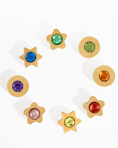 Bauspiel Spieltaler, acht Holzteile in Stern- und Kreisform mit farbigen Glitzersteinen