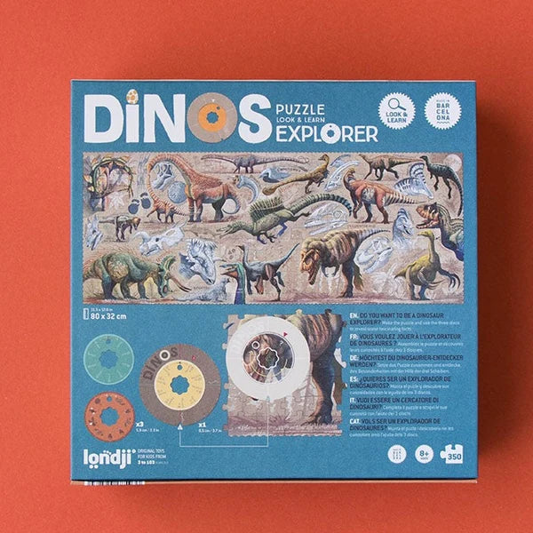 Rückseite des Londji Dino Explorer Puzzles mit Dinosaurier-Szene und farbigen Erkunder-Rädern