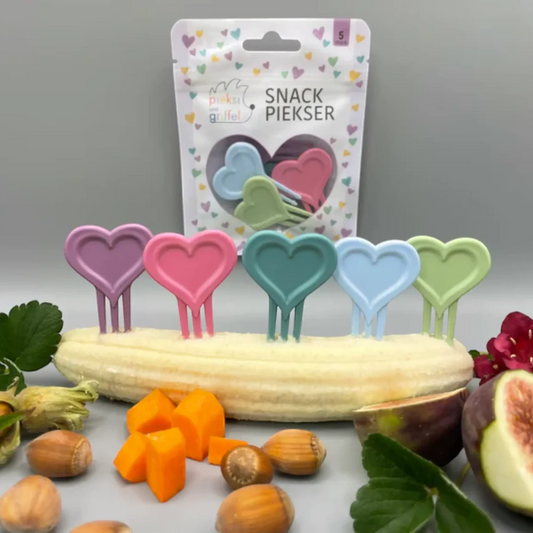Pieksi und Griffel Snack-Piekser mit fünf Herzformen in Rosa, Pink, Grün, Hellblau und Dunkelgrün vor Verpackung