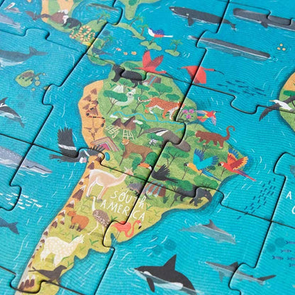 Londji Animal Planet Puzzle mit Südamerika, grünen Kontinenten mit bunten Tieren, blaues Meer mit Fischen