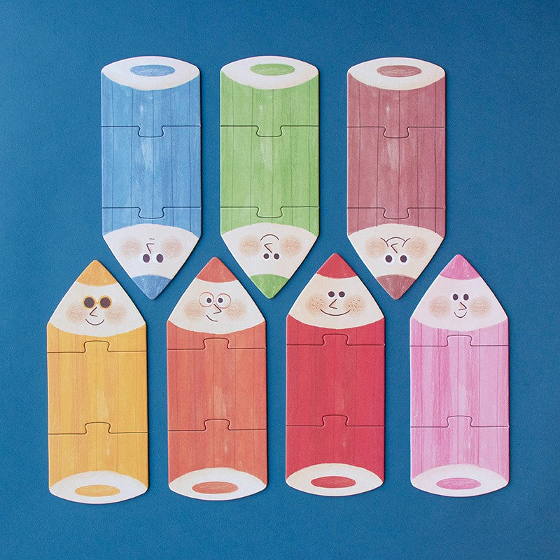 Londji My Colours: sieben gelegte Buntstift-Puzzles in verschiedenen Farben auf blauem Grund