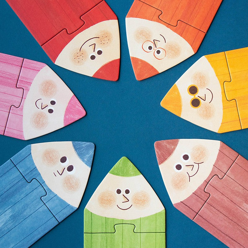 Londji My Colours: Buntstiftspitzen mit Gesichtern als Puzzleteile im Kreis gelegt